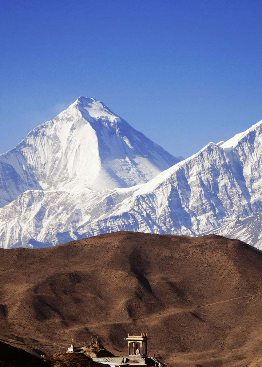 Trekkers traversing scenic high-altitude Himalayan mountain trail